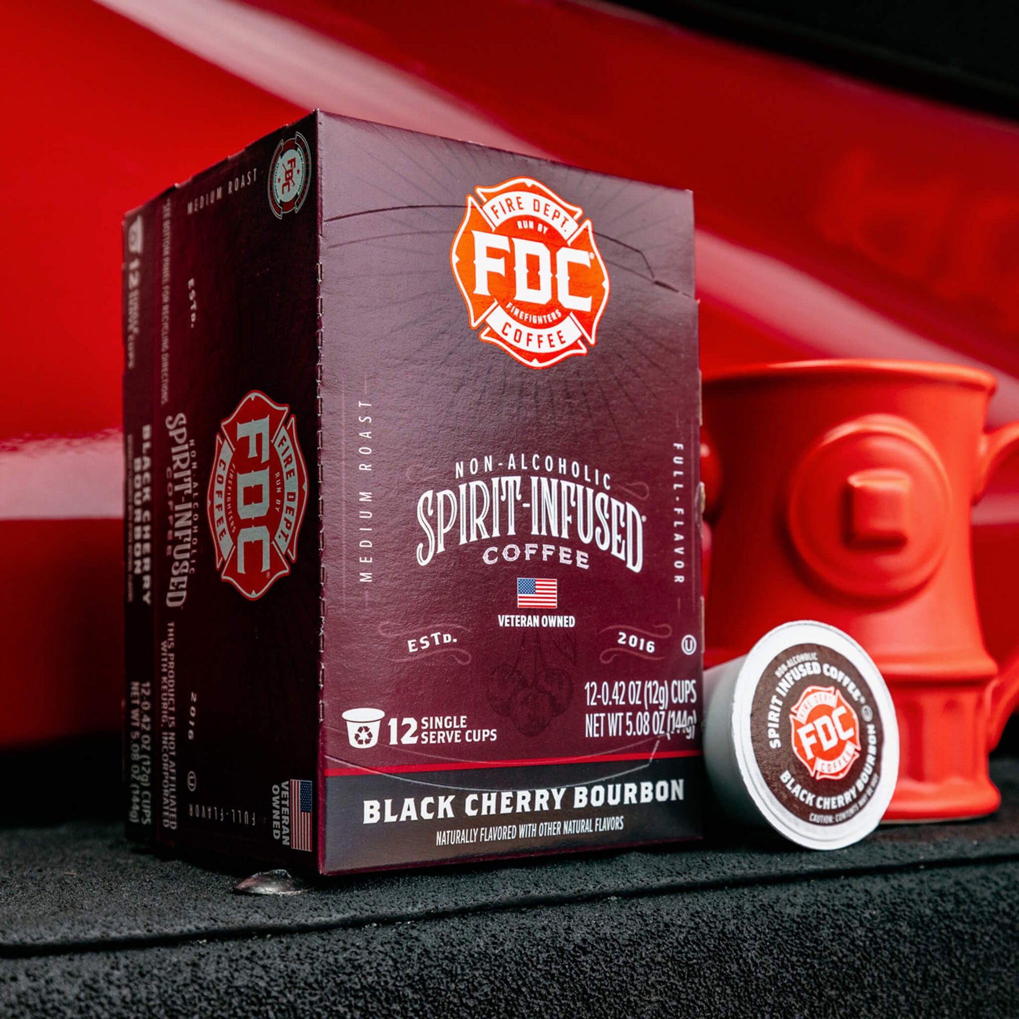 An image of the front of a box of Black Cherry Bourbon Infused Coffee Pods.
